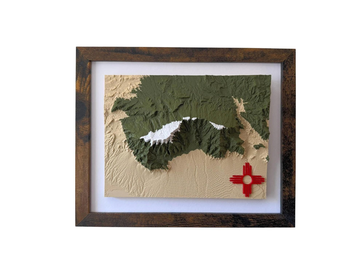 Multicolor Sandia Mountains terrain map with a red Zia symbol in a wood frame
