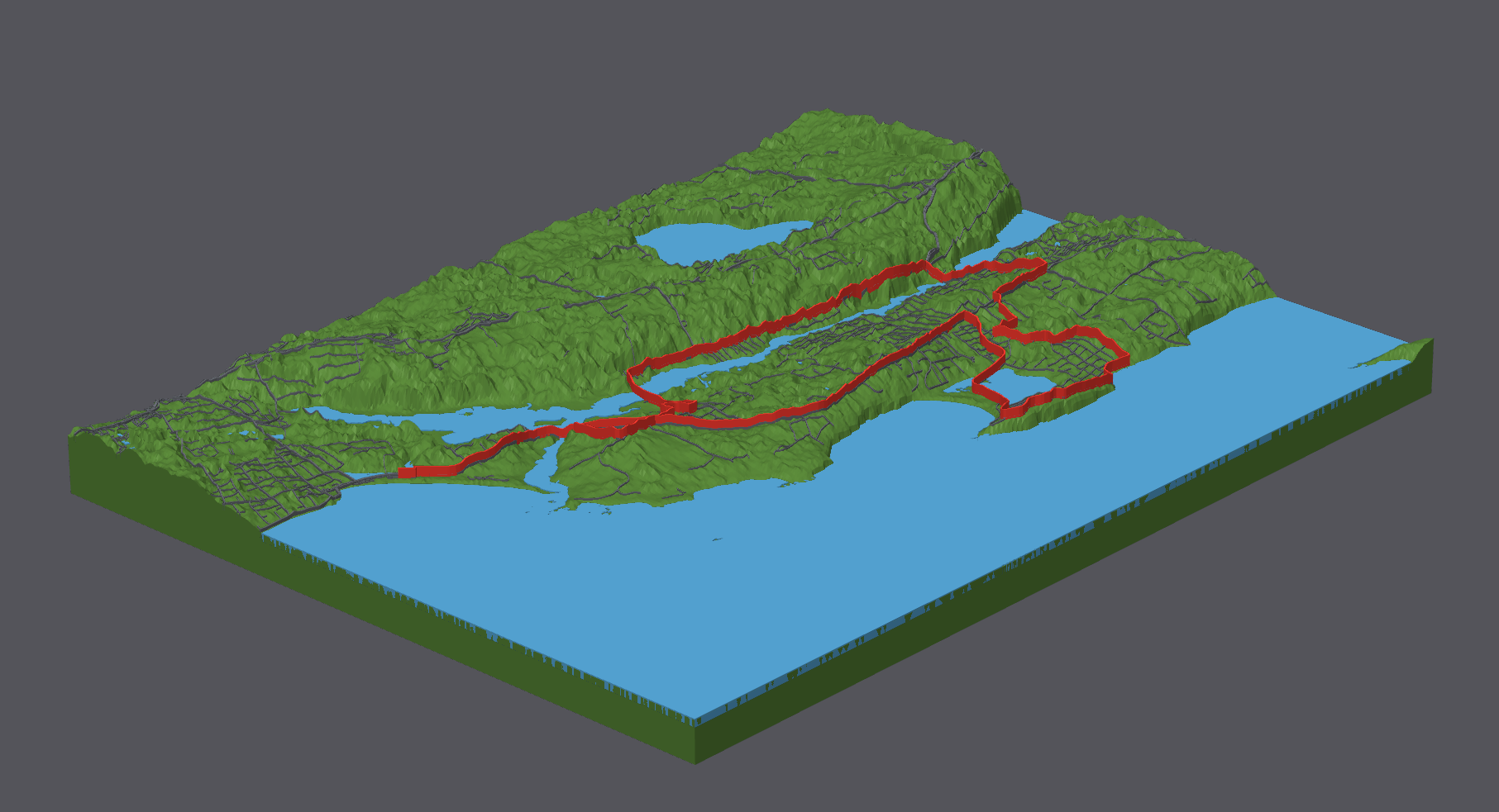 Angled view of the generator running model with a tall red route above a broad green surface and light blue water.